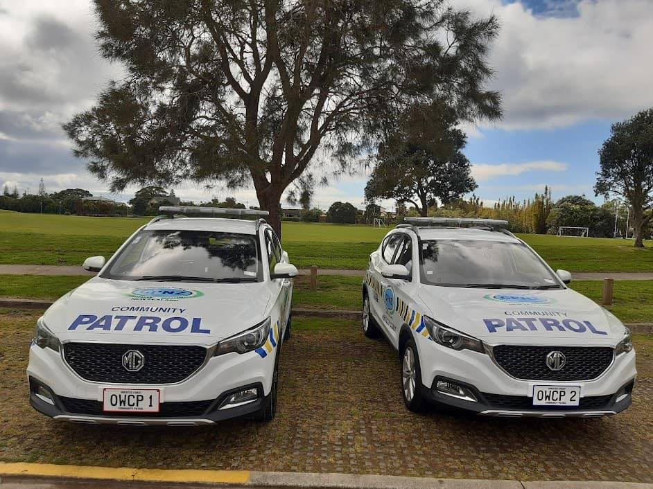 Two marked Hibiscus Coast Community Patrol vehicles parked beside a local reserve, ready for a shift.